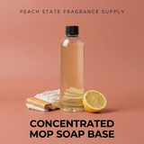Bottle of concentrated mop soap base with a lemon and washcloth on a peach background, branded 'Peach State Fragrance Supply'.